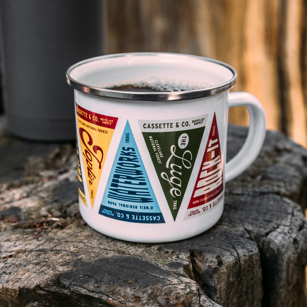 trail pennant camp mug sitting on tree stump