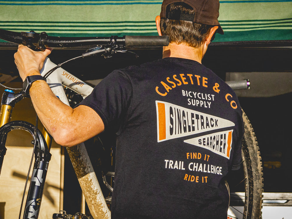 mountain biker loading bike into back of camper van