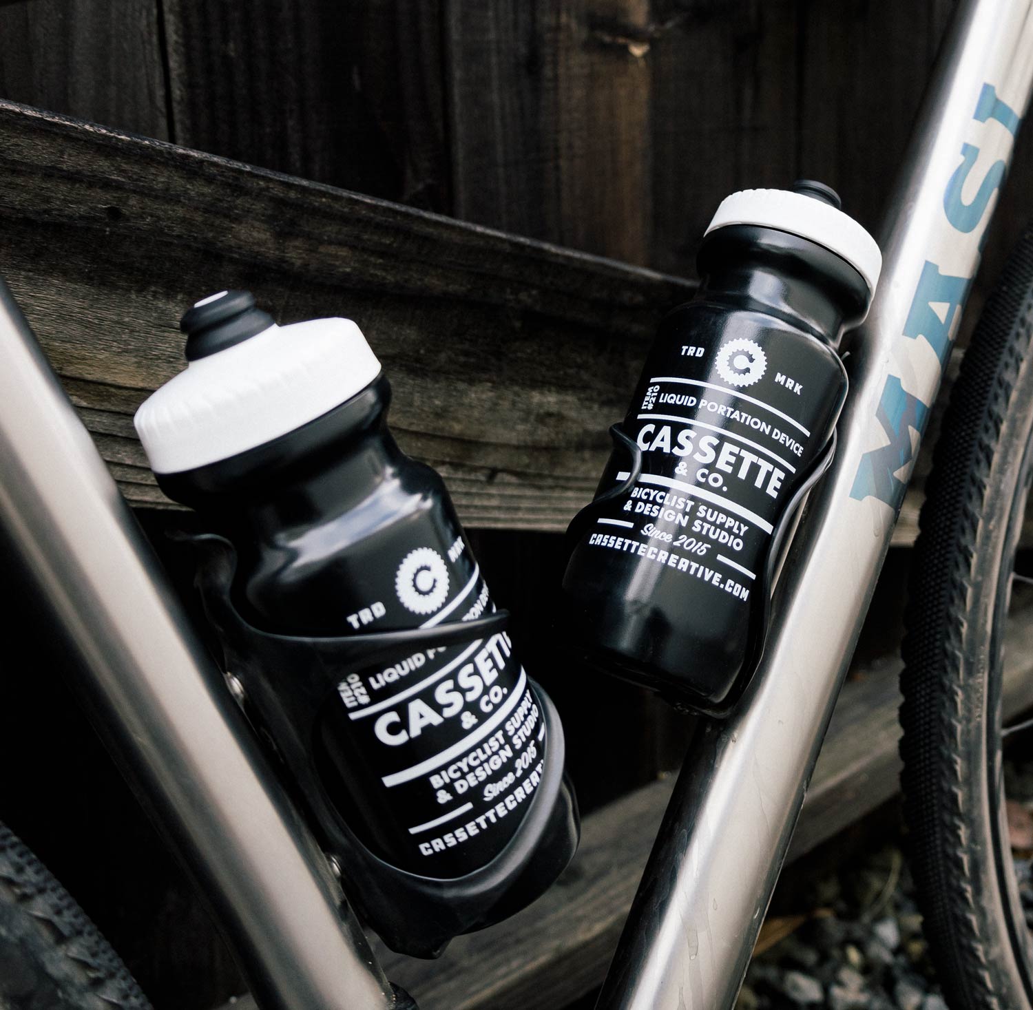 cassette and co black water bottles in a titanium bike
