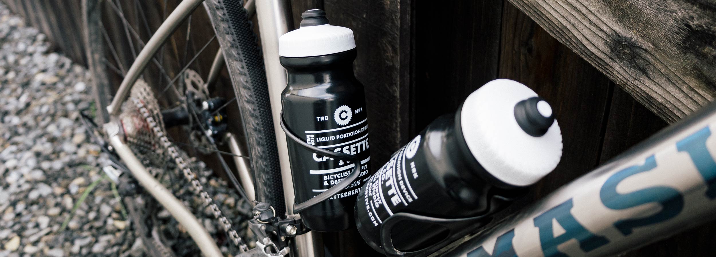 black bottles in a titanium gravel bike