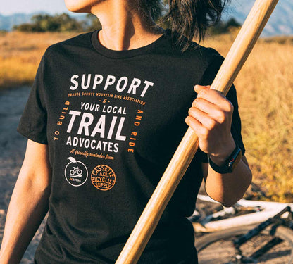 woman wears octmba tee while working on a trail